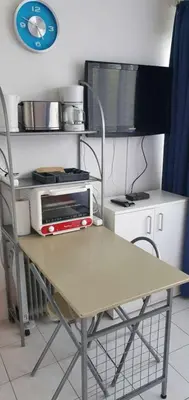 a kitchen with a table with a toaster oven on it at Gruissan studio aux Amarines au bord de la plage du Grazel in Gruissan