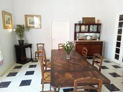 a dining room with a wooden table and chairs at OCC34 - Capestang - Villa Quinlan in Capestang