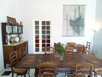 a dining room with a wooden table and chairs at OCC34 - Capestang - Villa Quinlan in Capestang