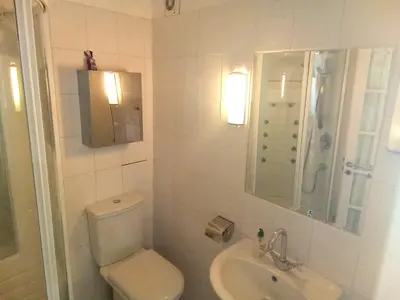 a white bathroom with a toilet and a sink at OCC34 - Capestang - Villa Quinlan in Capestang