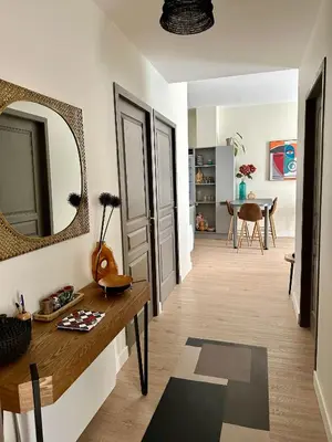 a living room with a table and a mirror at Coural’ Home in Narbonne