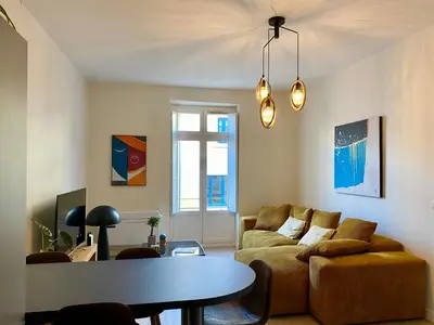 a living room with a couch and a table at Coural’ Home in Narbonne