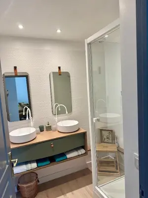 a bathroom with two sinks and a mirror at Coural’ Home in Narbonne