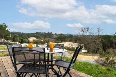 a table with two chairs and two cups on it at Le Soleil du Lac - Parking Privatif - Terrasse - Netflix - Clim in Carcassonne