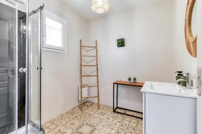 a bathroom with a sink and a shower at Le Soleil du Lac - Parking Privatif - Terrasse - Netflix - Clim in Carcassonne