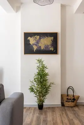 a living room with a map on the wall and a plant at Ò Grand Carnot/Hyper centre/Proche Gare in Carcassonne