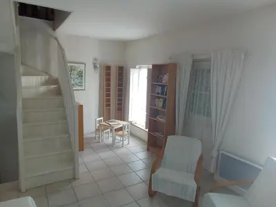 a staircase with two vases on a shelf next to a mirror at OCC34 - Capestang - Vigneron in Capestang