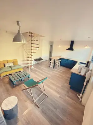 a living room with a staircase and a couch at Maison de campagne dans un domaine viticole in Tautavel