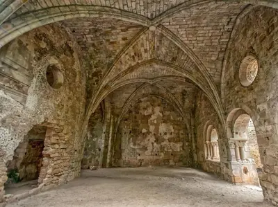 an archway in an old stone building with arches at Gîte en pleine nature - Parc, Piscine, Jacuzzi in Brézilhac
