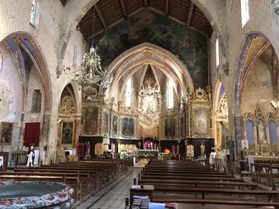 a church with wooden pews and a large altar at Gîte en pleine nature - Parc, Piscine, Jacuzzi in Brézilhac
