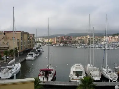a group of boats docked in a marina with buildings at Gruissan (Aude) Appartement calme, vue sur port de plaisance -Clim, Empl.Parking in Gruissan