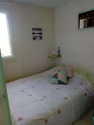 a bedroom with a large bed in a room at Gruissan (Aude) Appartement calme, vue sur port de plaisance -Clim, Empl.Parking in Gruissan