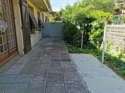 a walkway outside of a house with a fence at villa plain pied 4 chambres à 100m de la plage in Port-la-Nouvelle