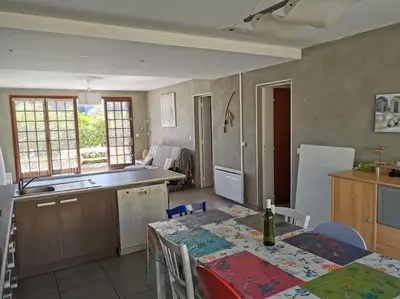 a kitchen with a table and a dining room at villa plain pied 4 chambres à 100m de la plage in Port-la-Nouvelle