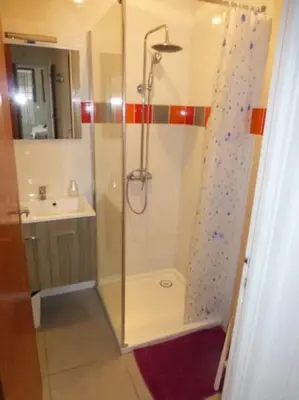 a shower with a glass door in a bathroom at villa plain pied 4 chambres à 100m de la plage in Port-la-Nouvelle