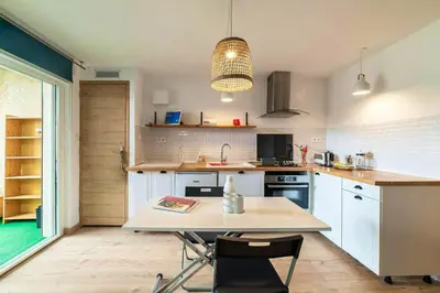 a kitchen with a table and chairs in it at Charmant appartement à Sigean - 23 m² - Climatisation in Sigean