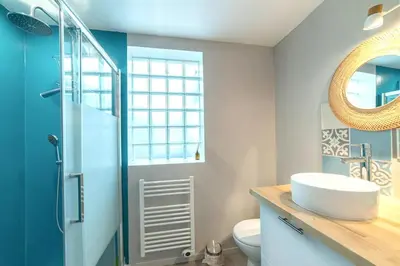 a bathroom with a sink and a toilet and a mirror at Charmant appartement à Sigean - 23 m² - Climatisation in Sigean