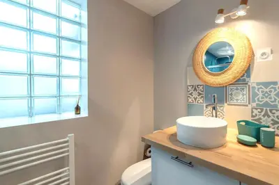 a bathroom with a sink and a mirror on a counter at Charmant appartement à Sigean - 23 m² - Climatisation in Sigean