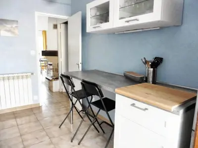 a kitchen with a table and chairs in a room at Maison avec jardin à Sigean - Confort et tranquillité in Sigean