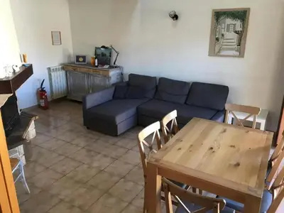 a living room with a blue couch and a table at Maison avec jardin à Sigean - Confort et tranquillité in Sigean