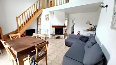 a living room with a blue couch and a table at Maison avec jardin à Sigean - Confort et tranquillité in Sigean