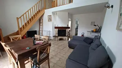 a living room with a blue couch and a table at Maison avec jardin à Sigean - Confort et tranquillité in Sigean