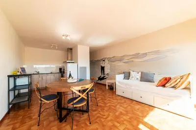 a living room with a white couch and a table at Appartement moderne vue mer à Port-la-Nouvelle — 42 m² in Port-la-Nouvelle
