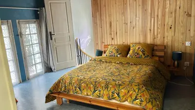a bedroom with a bed with a comforter on it at Chez BEN avec tout le confort clim wifi Netflix gratuit in Castres