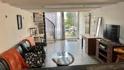 a living room with a couch and a tv at Chez BEN avec tout le confort clim wifi Netflix gratuit in Castres