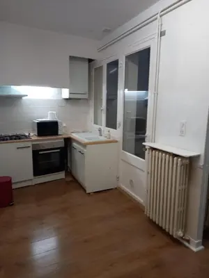 a kitchen with white cabinets and a counter top at La Maison de Chouquette in Limoux