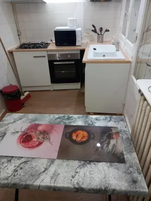 a kitchen with a table with a picture on it at La Maison de Chouquette in Limoux