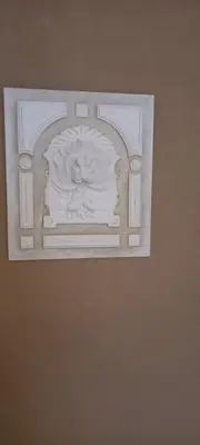 a statue of a lion on a wall at La Maison de Chouquette in Limoux