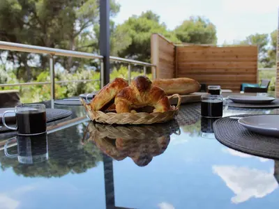 a table with a basket of bread on top of it at Cottage du Lac 63 in Olonzac