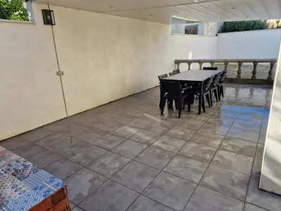 a room with a table and chairs on a tiled floor at Villa BEETHOVEN in Carcassonne