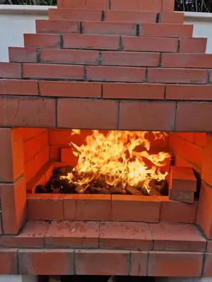 a brick oven with a fire in it at Villa BEETHOVEN in Carcassonne