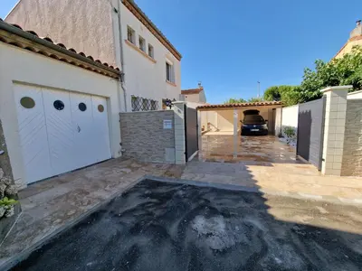 a garage with a car parked next to a house at Villa BEETHOVEN in Carcassonne