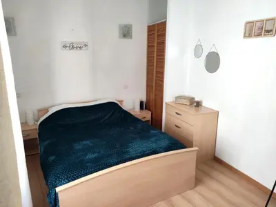 a bedroom with a bed with a green blanket at Confortable maison de village en pierre typique in Molitg les Bains
