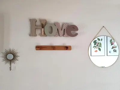 a mirror and a sign that says love on a wall at Confortable maison de village en pierre typique in Molitg les Bains