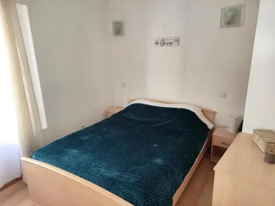 a small room with a bed with a green blanket at Confortable maison de village en pierre typique in Molitg les Bains
