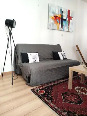 a couch in a living room with a camera at Confortable maison de village en pierre typique in Molitg les Bains