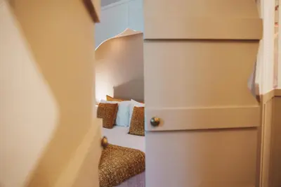 a room with a bed with pillows on it at Maison d'hôtes de charme 