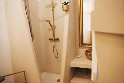 a bathroom with a shower and a mirror at Maison d'hôtes de charme 