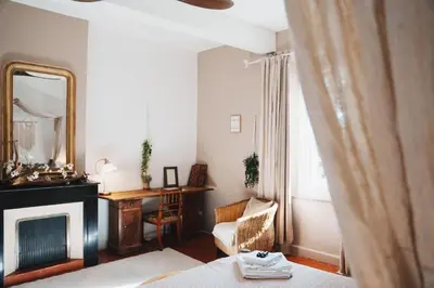 a living room with a fireplace and a mirror at Maison d'hôtes de charme 