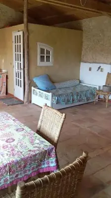 a room with a bed and a table and chairs at la Bergerie in Salles-sur-lʼHers