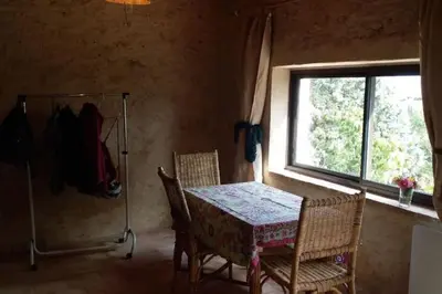 a dining room with a table and chairs and a window at la Bergerie in Salles-sur-lʼHers