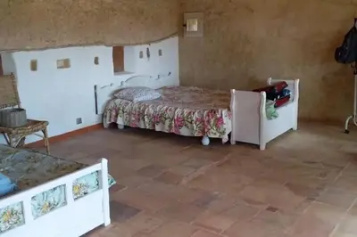 a bedroom with two beds and a tiled floor at la Bergerie in Salles-sur-lʼHers