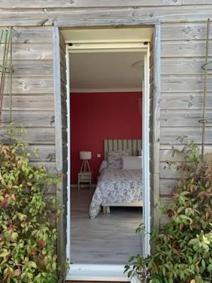 a door leading into a bedroom with a bed at Villa avec piscine à débordement vue exceptionnelle in Puéchoursi