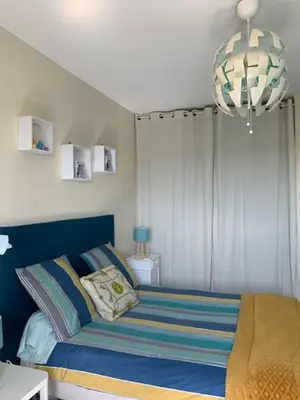 a bedroom with a bed and a chandelier at Villa avec piscine à débordement vue exceptionnelle in Puéchoursi