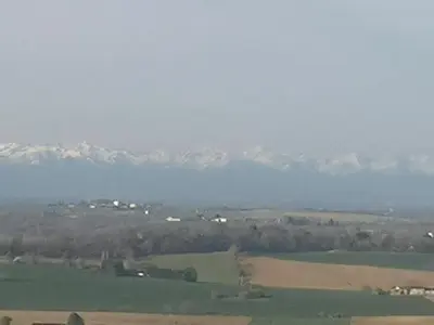 a view of a field with mountains in the background at Villa avec piscine à débordement vue exceptionnelle in Puéchoursi
