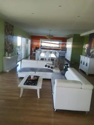 a living room with two white couches and a table at Villa avec piscine à débordement vue exceptionnelle in Puéchoursi